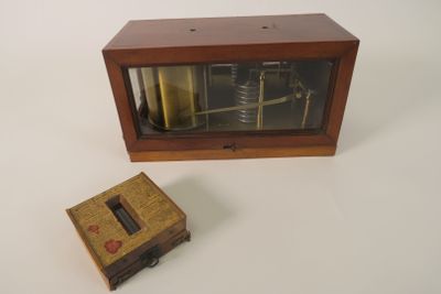 a small wooden box with a clock inside of it