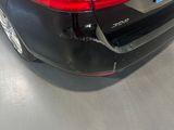 a picture of a black car parked in a garage