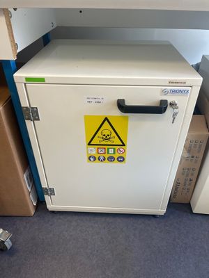 a white cabinet with a yellow hazard sign on it