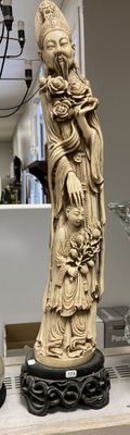 a statue of a woman holding a child on a shelf