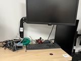 a computer desk with a monitor, keyboard and mouse on it