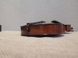 a violin sitting on the floor in front of a wall