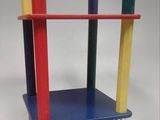 a small wooden table with pencils on it