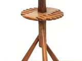 a wooden stand with a bowl on top of it