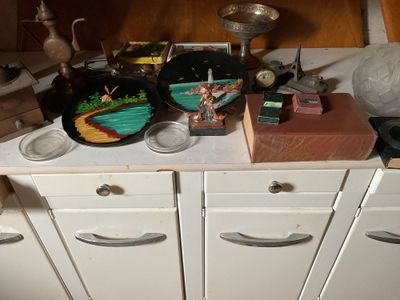 a small kitchen with a lot of clutter on the counter