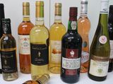 many bottles of wine that are lined up on the table