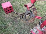 a red tractor with a red block attached to it