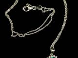 a necklace with a green stone on a chain
