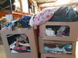 two boxes with clothes on top of them in a warehouse