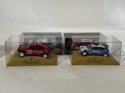 two toy cars in a display case on a white surface