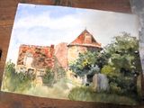 une aquarelle représentant une maison posée sur une table