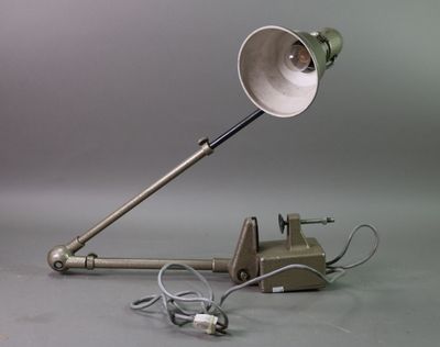 a lamp that is sitting on the ground next to a telephone