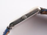 an image of a close up of a watch on a white surface
