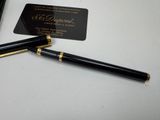 a pen and a business card sitting on a table