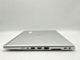an open laptop computer sitting on top of a white surface