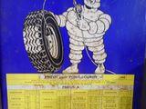 a sign with a picture of a man holding a tire