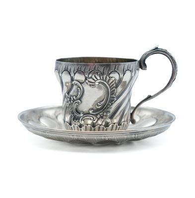 silver cup and saucer on a saucer on a white background