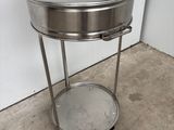 a metal table with a pot on top of it