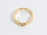 an image of a gold ring on a white surface