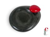 a black stone with a red heart on it