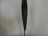 bronze sculpture of a bird on a stand on a yellow cushion