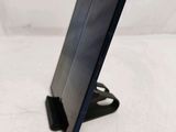 a tablet computer sitting on a stand on a white surface