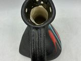 a black vase with a red and blue design on it