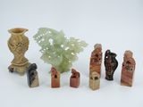 seven pieces of carved figurines sitting next to each other