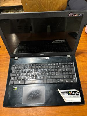 a laptop that is open on a wooden table