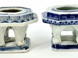 two blue and white vases sitting next to each other