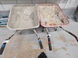 two wheelbarrows that are sitting in the garage