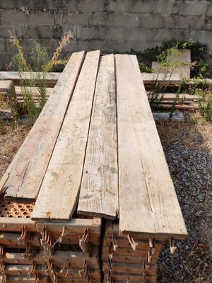 several pieces of wood are stacked on top of each other in a pile