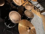 a drum set up in a room with a rug