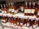 many bottles of wine on the shelves in the store