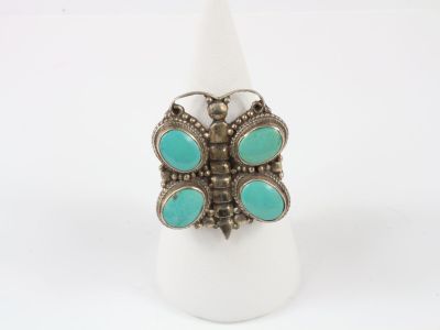 a close up of a ring with turquoise stones on it