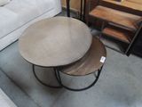 two tables that are sitting on the floor next to a couch