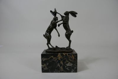 statue of two deers on a marble base on a white background