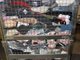 a metal cart with a lot of clothes in it