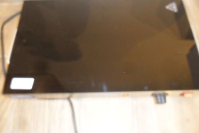 a laptop computer sitting on top of a wooden table