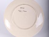 a white plate with writing on it sitting on a table
