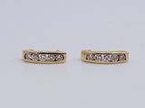a pair of diamond earrings on a white background