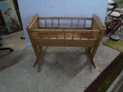 a baby crib that is made out of wood