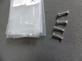 four screws in a plastic bag on a table