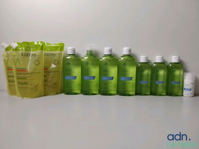 several bottles of hand sanitizer are lined up on a table