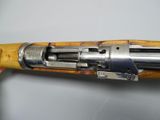a close up of a rifle with a wooden barrel and metal fittings