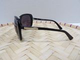 a close up of a pair of sunglasses on a woven basket