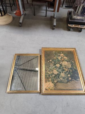 two framed pictures sitting on the floor next to each other