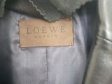the label is on the jacket of a woman ' s leather jacket