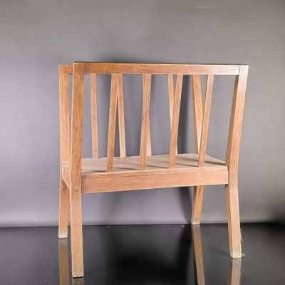 a wooden bench that is sitting on a black surface