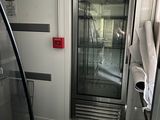 a glass door in the middle of a bathroom
